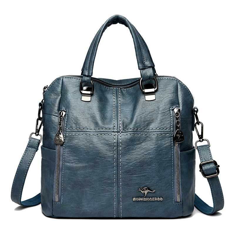 A dark blue leather fashion crossbody backpack bag with silver hardware.