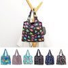 A collection of colorful reusable shopping bags hanging from a wooden hanger.