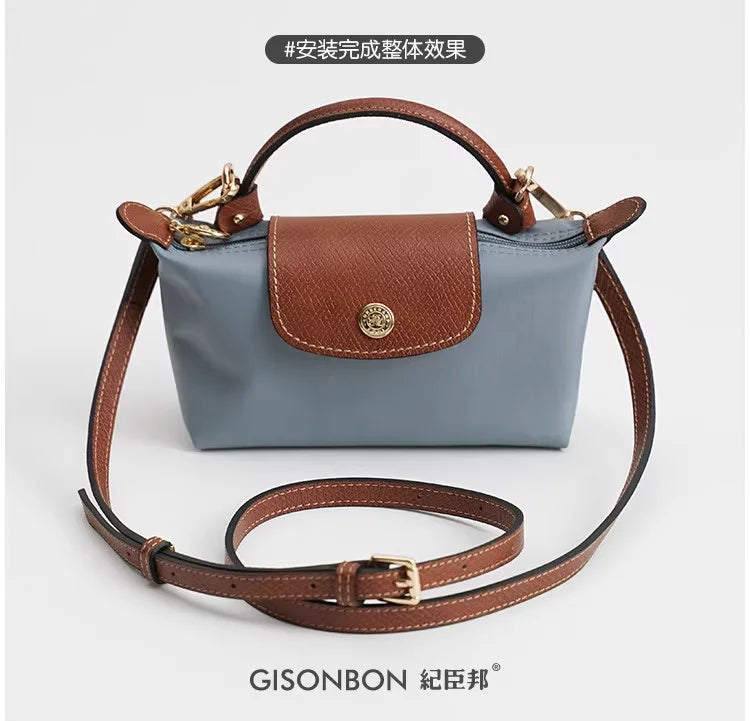 A light blue leather mini bag with brown leather straps and a matching strap set.