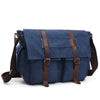 A dark blue canvas messenger bag for men with brown leather straps and buckles.