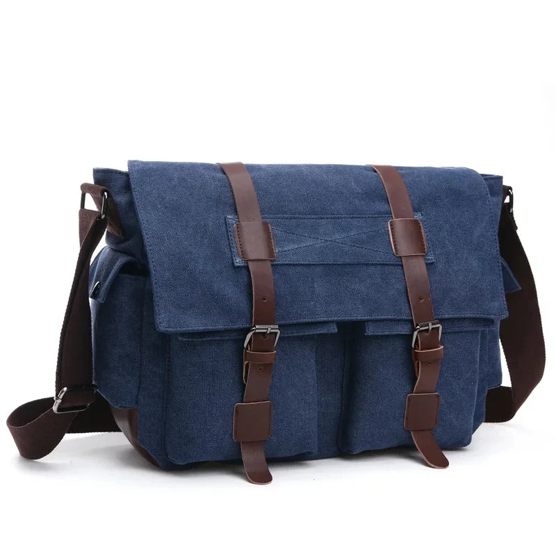 A dark blue canvas messenger bag for men with brown leather straps and buckles.