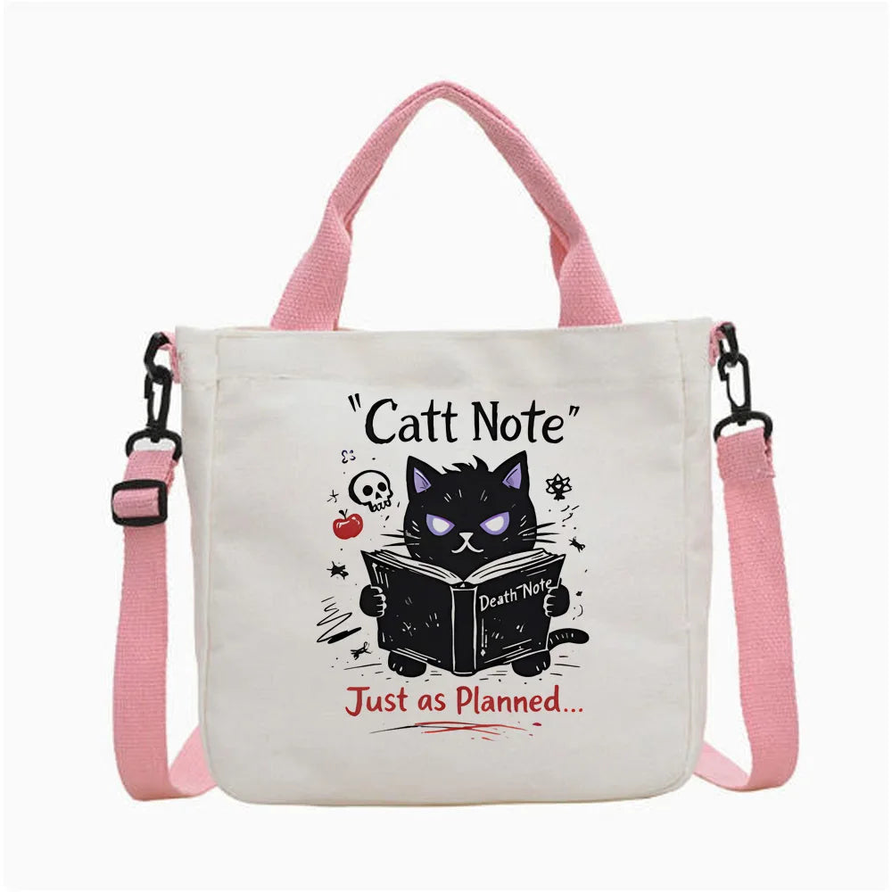 Bolso tote de lona blanca con diseño de gato negro, calavera y libro.