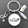 Silver keychain featuring a stethoscope charm and a medical syringe design.