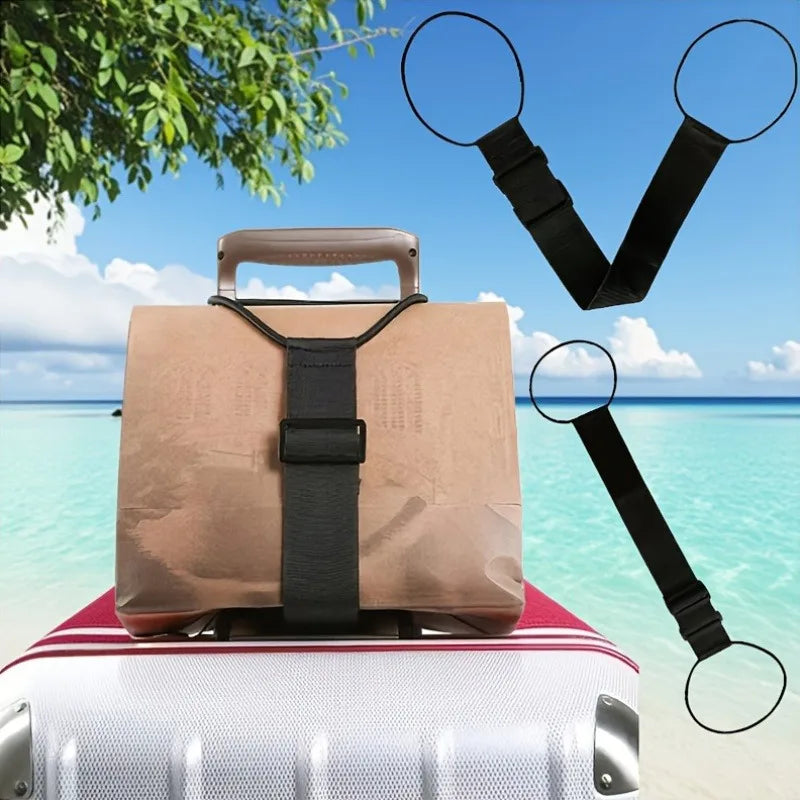 A tan luggage bag with a black strap is placed on top of a white suitcase, with a pair of black magnifying glasses nearby.