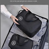 Schwarze Trocken-Nass-Make-up-Organizer-Tasche, offen, mit kleinerem passendem Beutel auf grau gestreiftem Stoff.