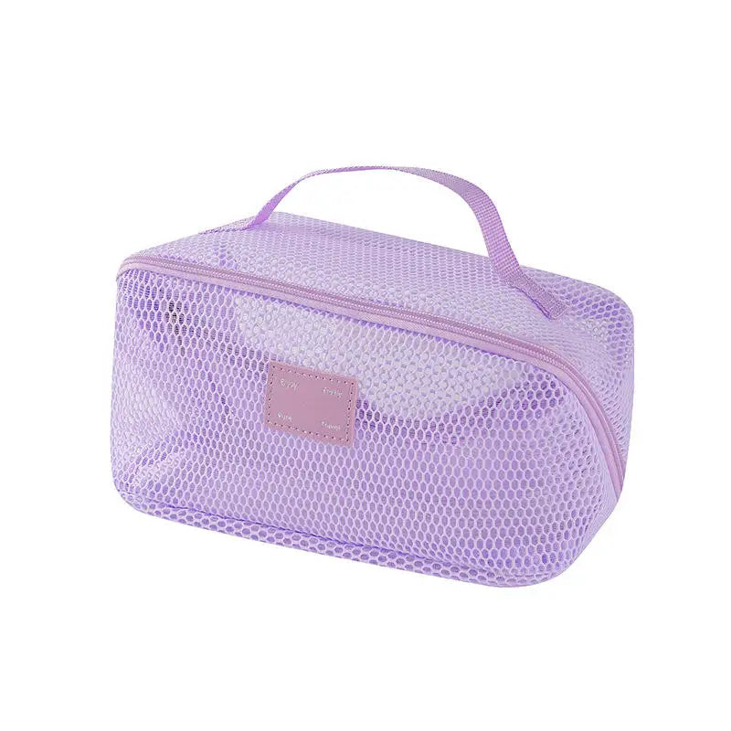 A lavender mesh cosmetic organizer pouch with a handle for storing makeup and toiletries.