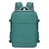 A teal compact travel backpack with gray mesh straps on the top
