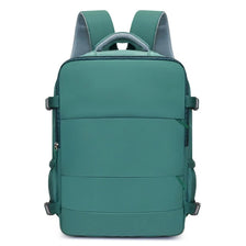 A teal compact travel backpack with gray mesh straps on the top
