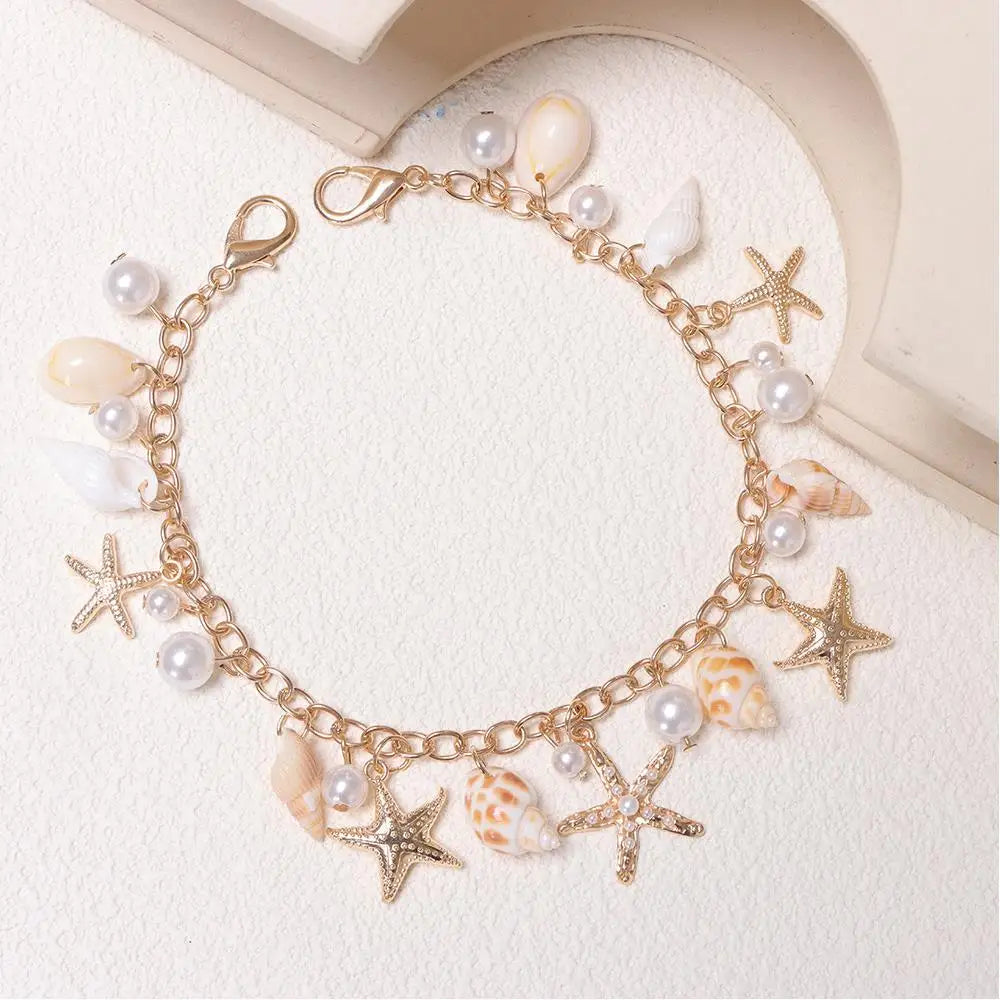 Gold layered chain necklace featuring pearl and seashell charms
