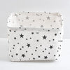 A white storage basket with a star pattern, used for desk organization.