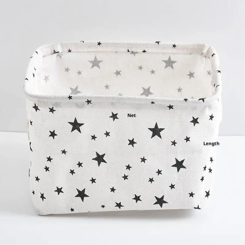 A white storage basket with a star pattern, used for desk organization.