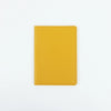 A plain yellow PU leather passport holder with stitched edges.