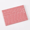 A pink crocodile embossed slim PU leather card holder wallet for women.