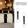 Two black nylon luggage straps are shown next to a white suitcase.