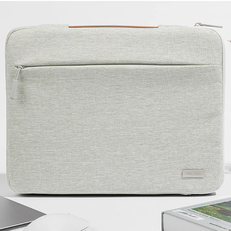 A light gray multi-pocket laptop sleeve with a leather handle shown from the top.