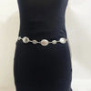 A vintage gold-plated sunflower smiley face waist chain worn on a person's black torso.