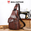 A brown genuine leather sling backpack with a Singer sewing machine visible in the background.