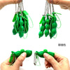 Green silicone fidget toy keychains being held by hands