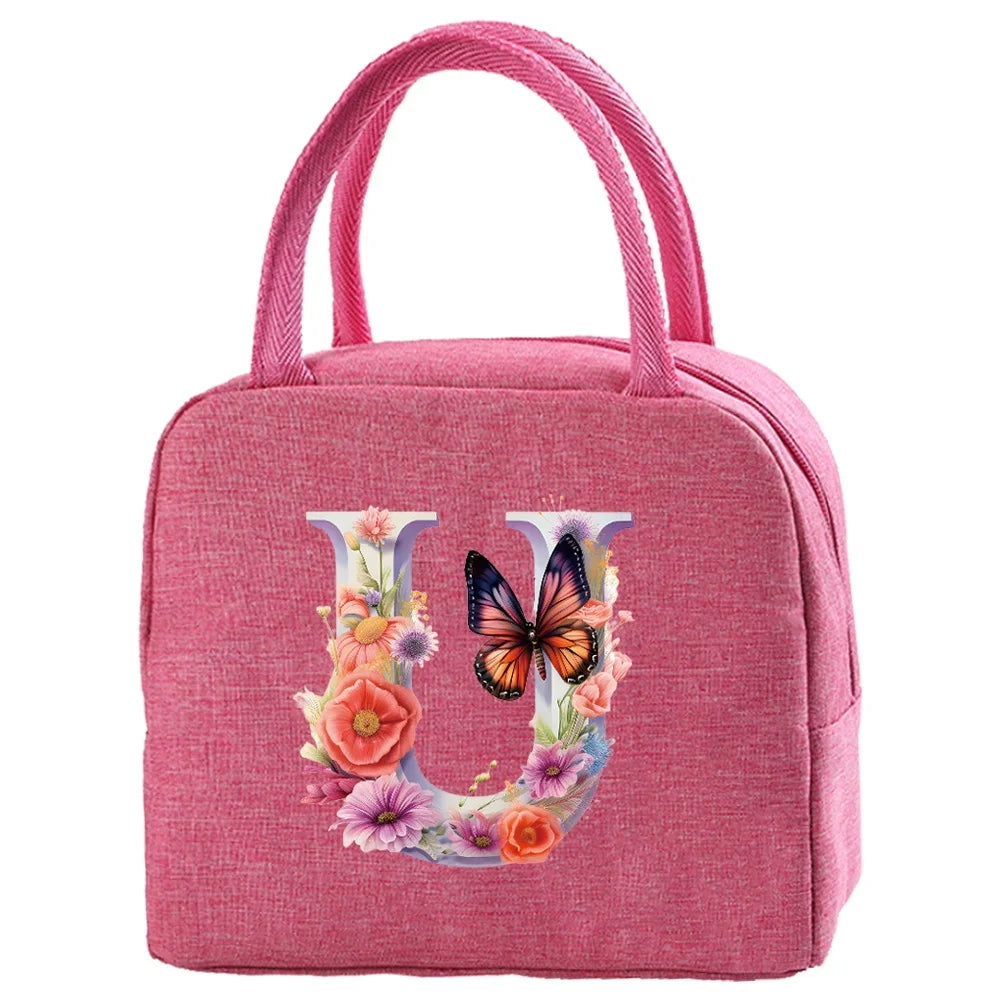 A pink insulated canvas lunch bag featuring a large letter U decorated with colorful flowers and butterflies.