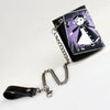 A black tri-fold chain card holder wallet with a purple and white graphic design and attached silver chain.