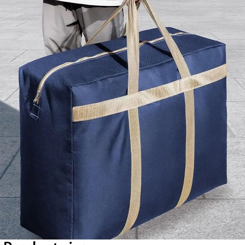 A navy blue foldable waterproof storage bag with tan straps resting on a gray tiled surface.