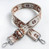 A beige and brown floral patterned leather strap for a crossbody bag.