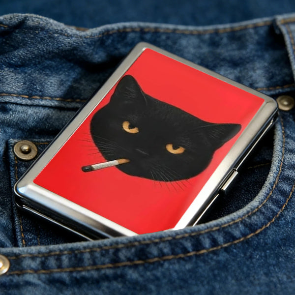 A black cat silhouette on a red background is displayed inside an Art Deco metal card holder, set against a denim fabric.