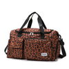 A brown leopard print travel duffel bag with black handles and a shoe compartment.