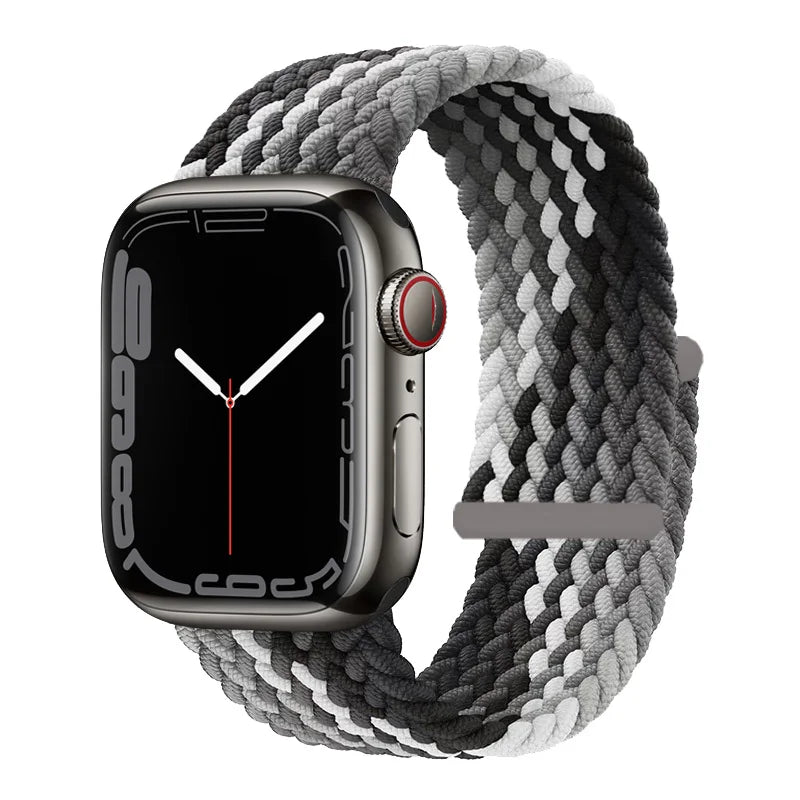 A black Apple Watch is shown with a gray braided stretch band wrapped around it.
