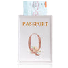 A pink leather passport holder with a gold embossed letter Q and floral design.