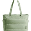 A sage green quilted tote bag with long handles.
