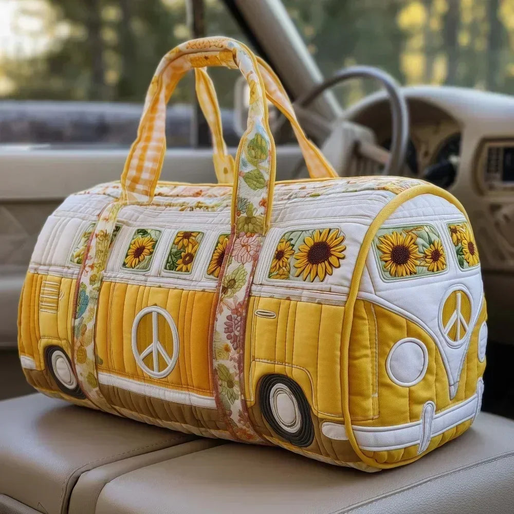 A yellow quilted travel duffle bag with a patterned fabric and handles resting on a light-colored car seat.