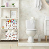 A white toilet and surrounding bathroom decor with a wooden shelf unit displaying various items.