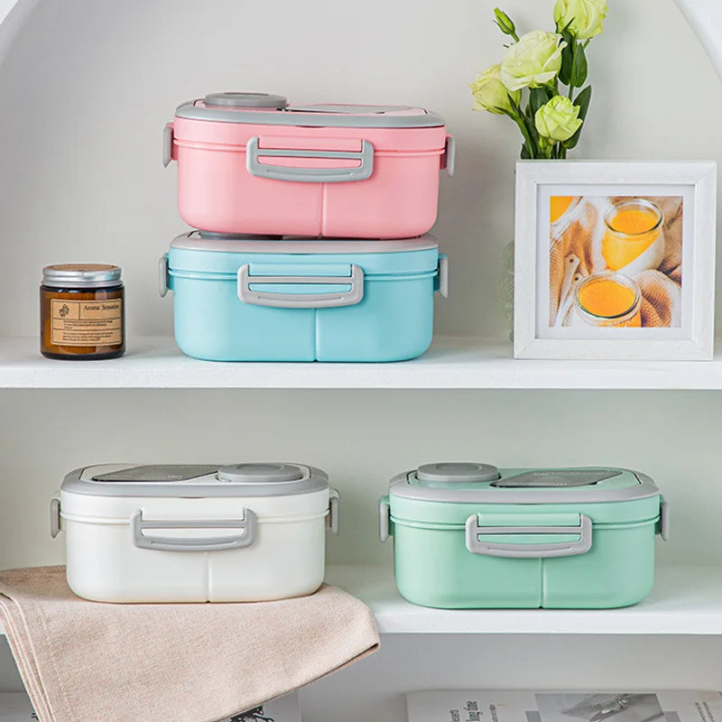 A set of three pink, blue, and mint green insulated lunch boxes displayed on a white shelf.
