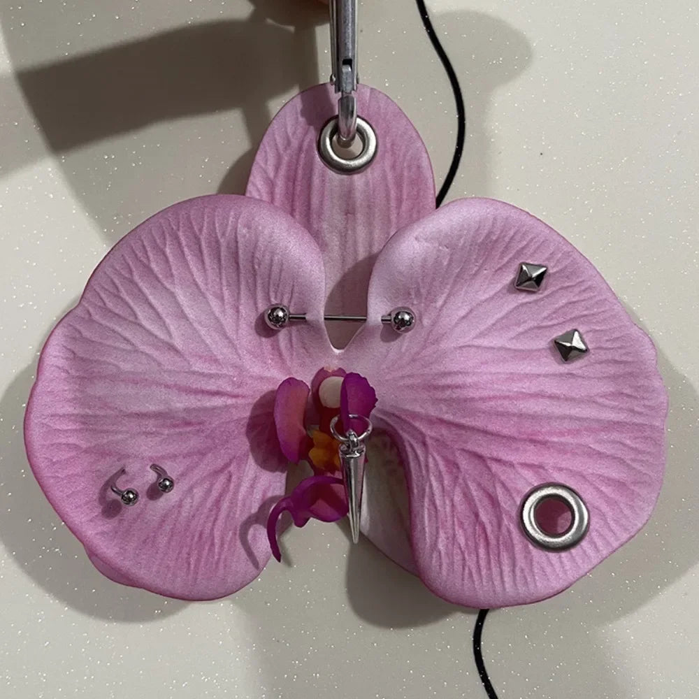 A realistic pink orchid flower keychain with purple accents hanging from a ring.