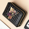 A black PU leather double-zip clutch wallet featuring a floral cartoon print with gold accents.