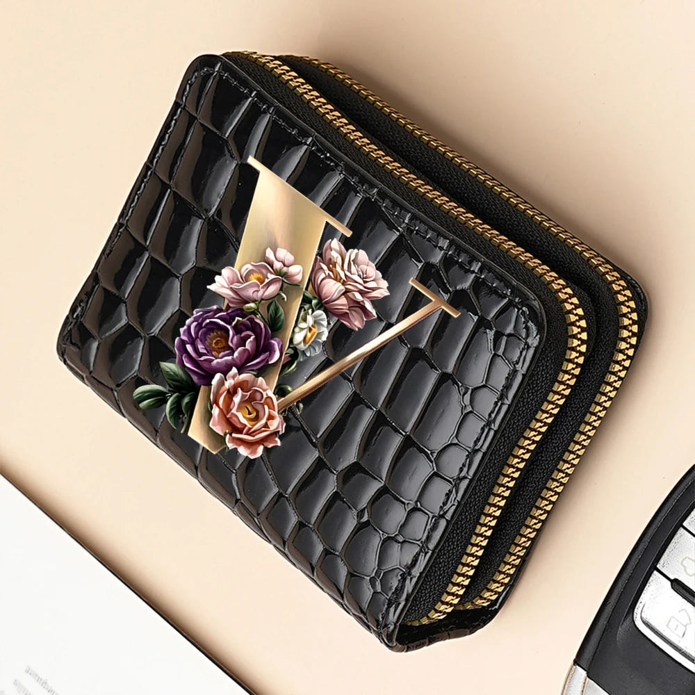 A black PU leather double-zip clutch wallet featuring a floral cartoon print with gold accents.