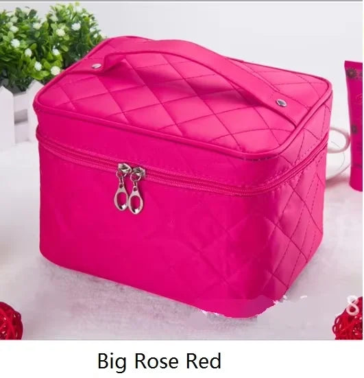 A bright pink quilted cosmetic storage box with a silver clasp resting on a white surface.