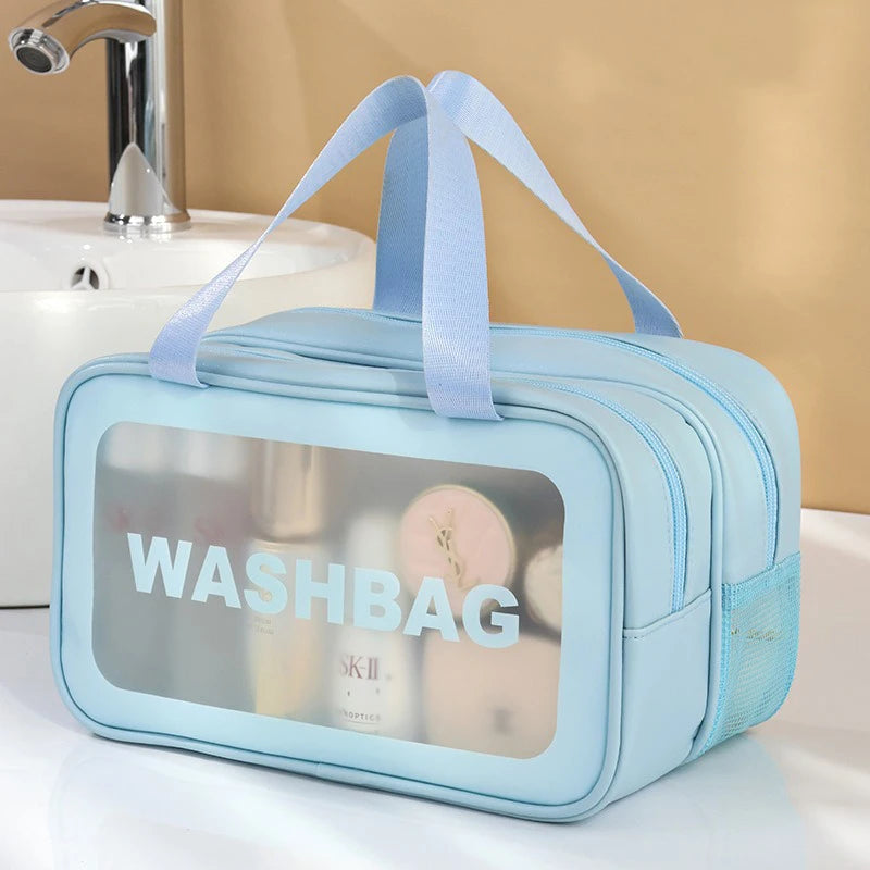 Light blue travel toiletry bag with a strap, featuring a clear window showing skincare products.