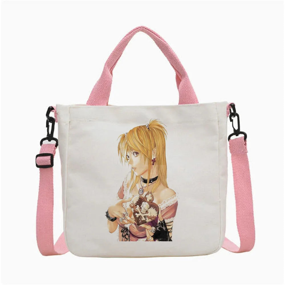 Bolso de tela blanco con tiras rosas y una ilustración de un personaje rubio.