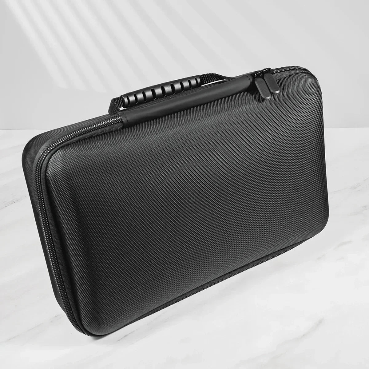 A black premium leather watch organizer travel case shown from above on a white marble surface.