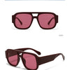 Front view of dark reddish-brown square sunglasses with a tortoiseshell frame and pink lenses.