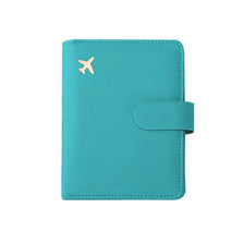 A teal leather passport organizer with a flap closure and an airplane logo embossed on the cover.