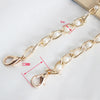 Gold chain strap with white pearls and a lobster clasp shown on a white background.
