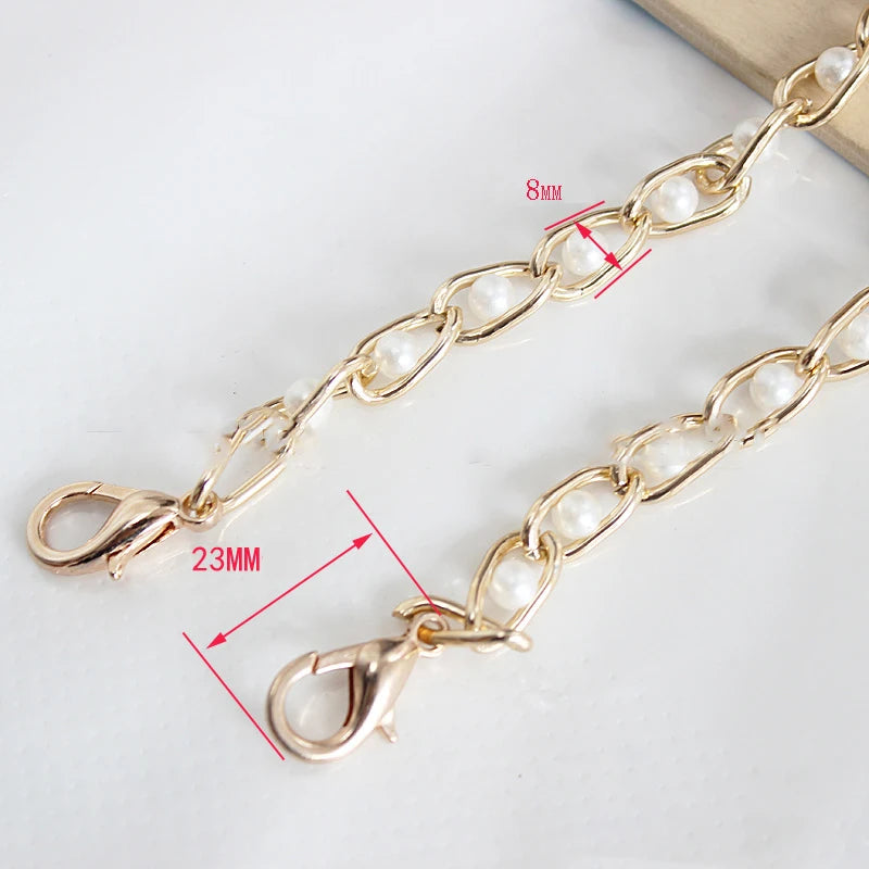 Gold chain strap with white pearls and a lobster clasp shown on a white background.