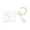 A white marble leather card holder and a beaded bracelet with a leather tag.