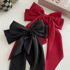 A set of elegant silk bow hair clips in black and red satin fabric.