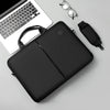 A black slim commuter laptop briefcase next to a silver pair of eyeglasses and a black strap.