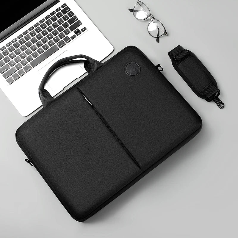 A black slim commuter laptop briefcase next to a silver pair of eyeglasses and a black strap.