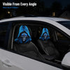 Two blue glowing gothic skull headrest covers installed in a car seat.